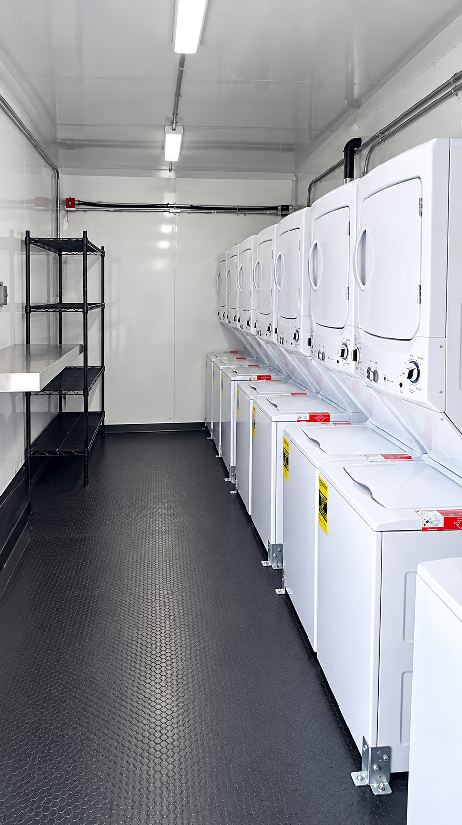 Rows of washers and dryers inside a mobile laundry trailer